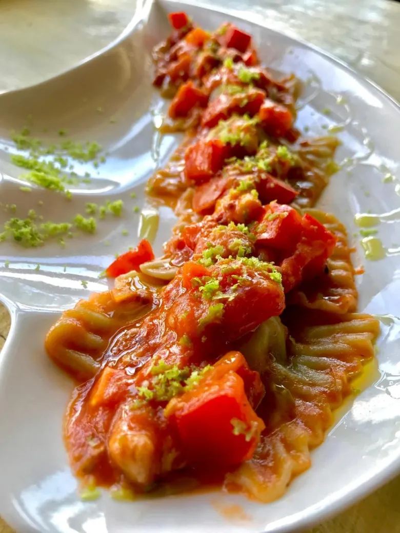 Octopus served over beetroot sauce with fresh tomato