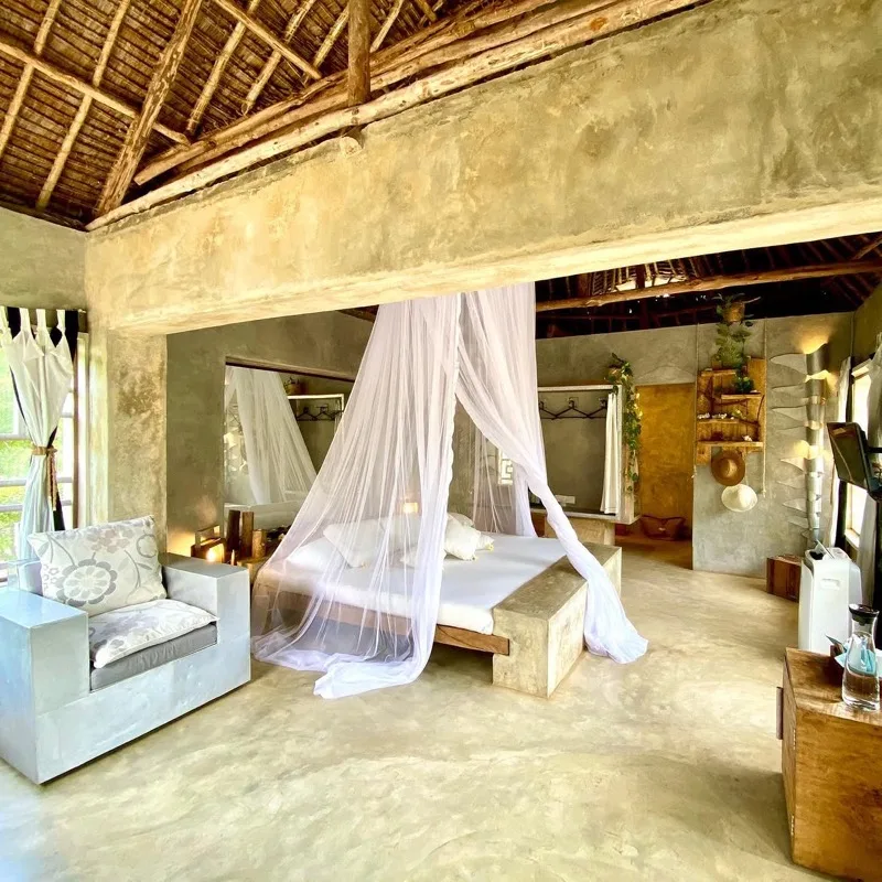 The Baobab King Suite with Afro-chic interiors opening onto a private outdoor area above Mida Creek