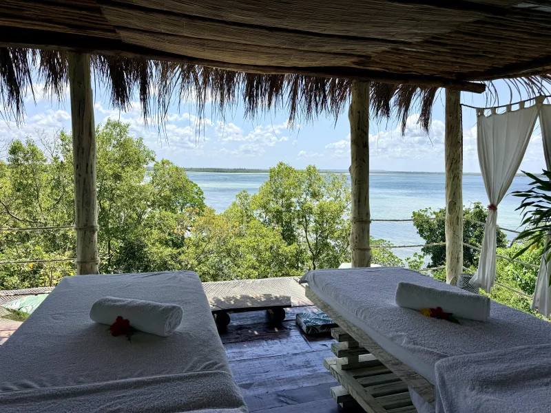 Rolled towels on the treatment beds with the open water of Mida Creek beyond