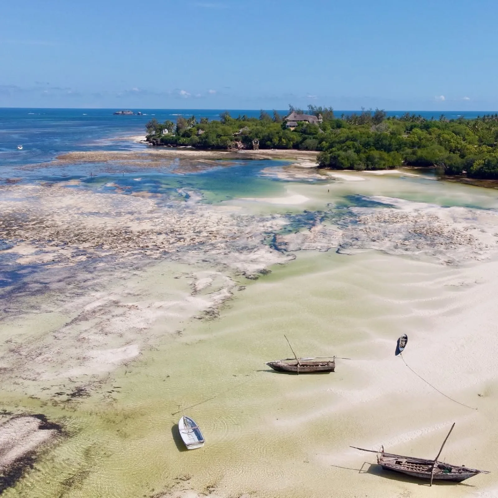 Thatched roofs seen from above with the creek stretching out beyond