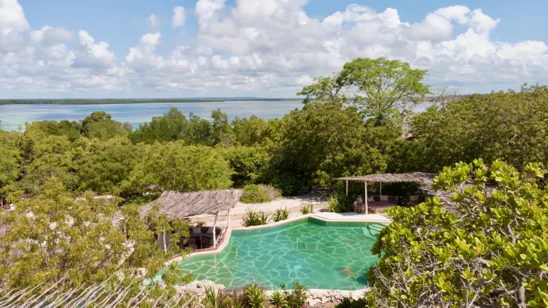 The pool set among the trees above Mida Creek, with the creek and the Indian Ocean beyond
