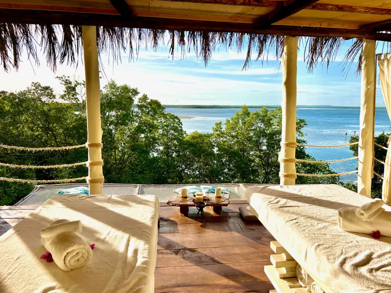 Outdoor stone bath and sunset aperitif overlooking Mida Creek at Jua Spa